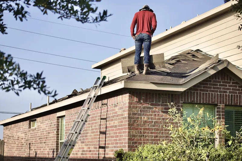 Professional roofer working on a residential roof in Ashwaubenon